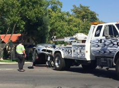Picture of tow truck hauling a car after a crash