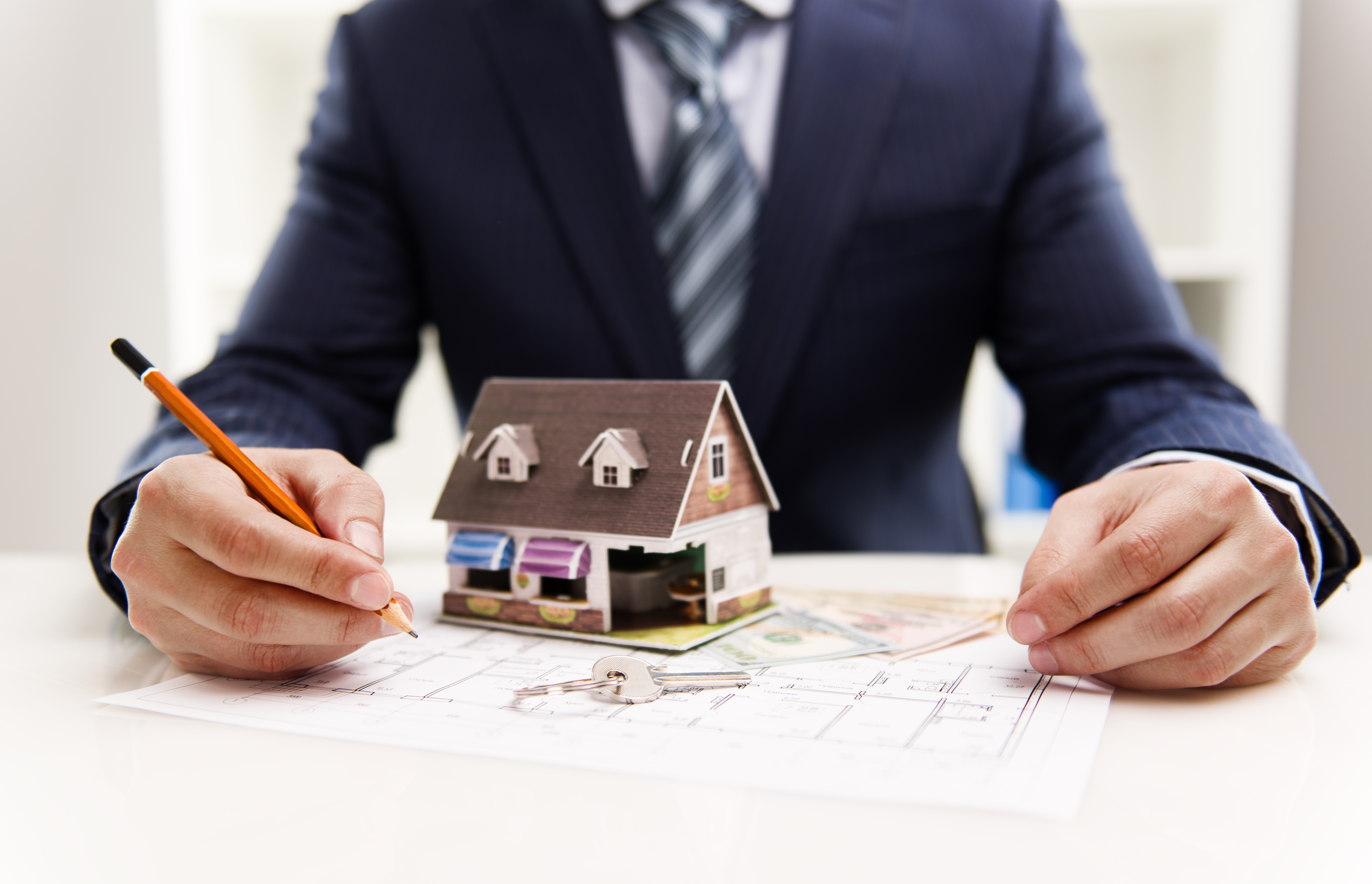 Picture of male architect drawing house plan