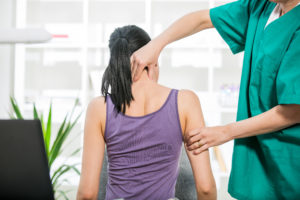 Photo of a Chiropractor Working on a Patient's Neck Injury