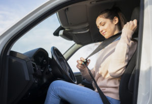  girl putting on seatbelt 